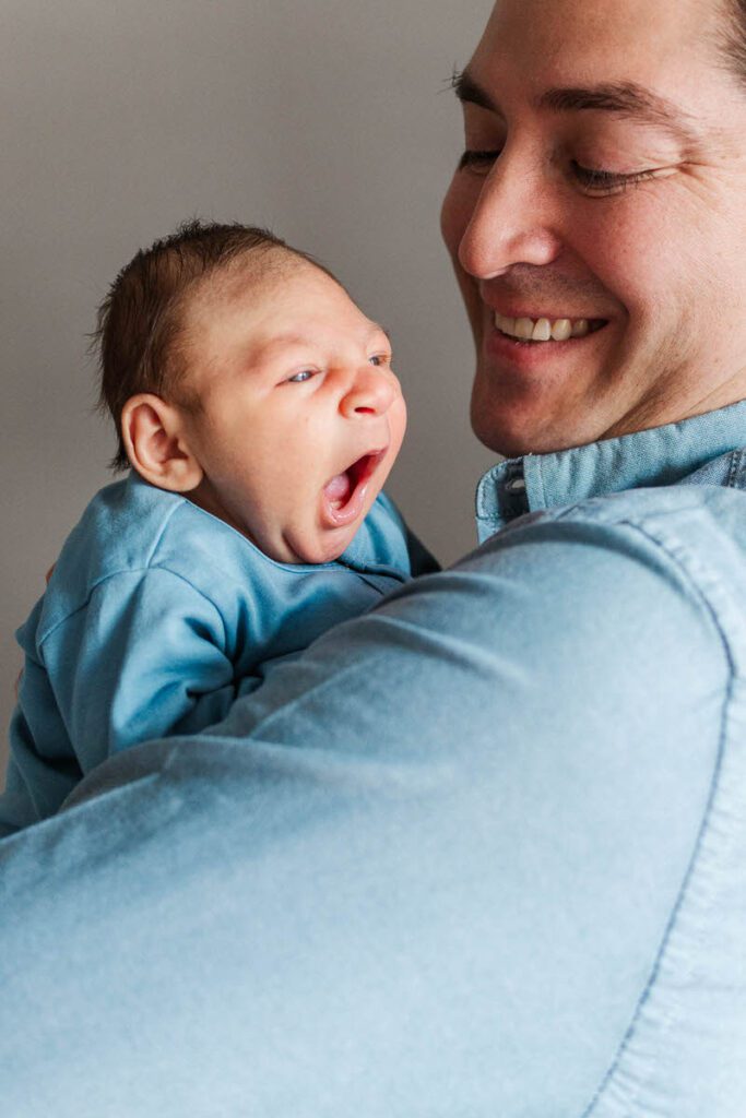 Dad holds baby during their Louisville in-home newborn session.