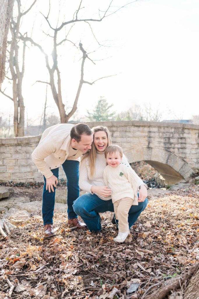 A mom and dad pose with their toddler during their family session at Anchorage Trail in Louisville, KY

Photos by Michelle Bordenkircher Photography