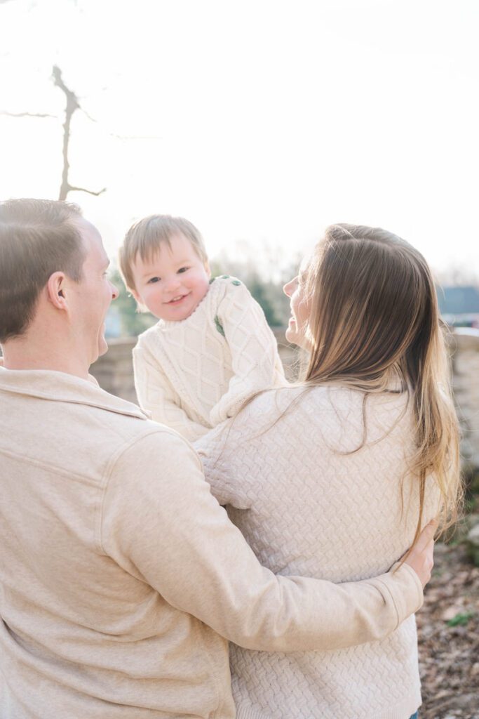 A mom and dad pose with their smiling toddler during their family session at Anchorage Trail in Louisville, KY

Photos by Michelle Bordenkircher Photography