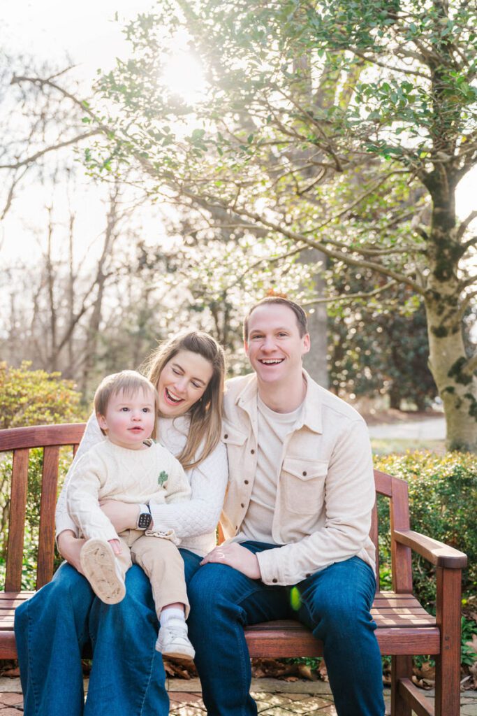 Parents sit on a bench smiling with their toddler during a family session at Anchorage Trail in Louisville, KY

Photos by Michelle Bordenkircher Photography