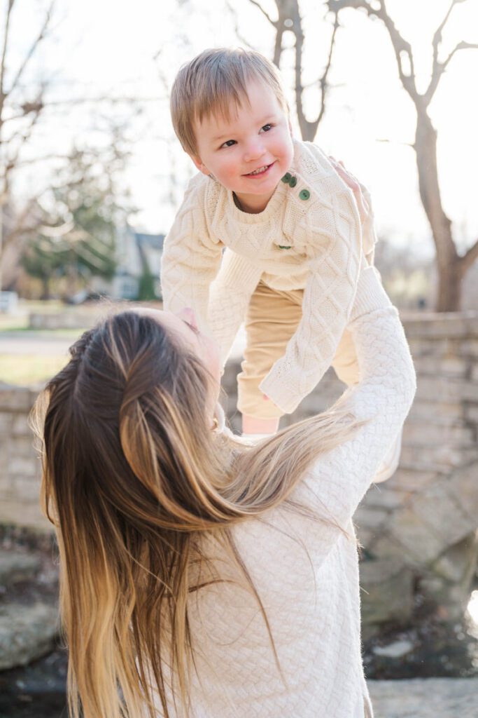 A mom lifts her son in the air to make him smile during their family session at Anchorage Trail in Louisville, KY

Photos by Michelle Bordenkircher Photography