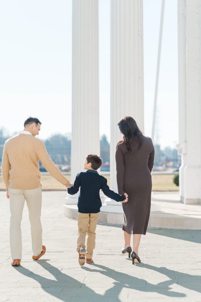 Family walking together during a winter family session at the Louisville Water Tower in Louisville Kentucky Photos by Michelle Bordenkircher Photography