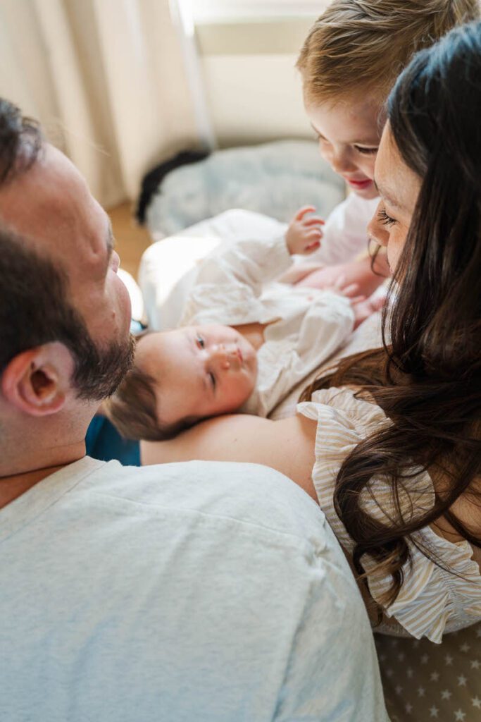 A family shares a sweet moment during their Louisville In-Home Family Photography Session. Photos by Michelle Bordenkircher Photography.