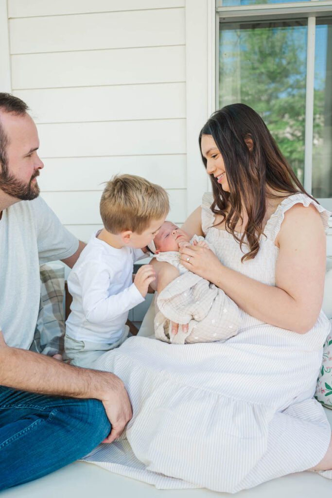 A family smiles at their new baby girl during their Louisville In-Home Family Photography Session. 

Photos by Michelle Bordenkircher Photography.