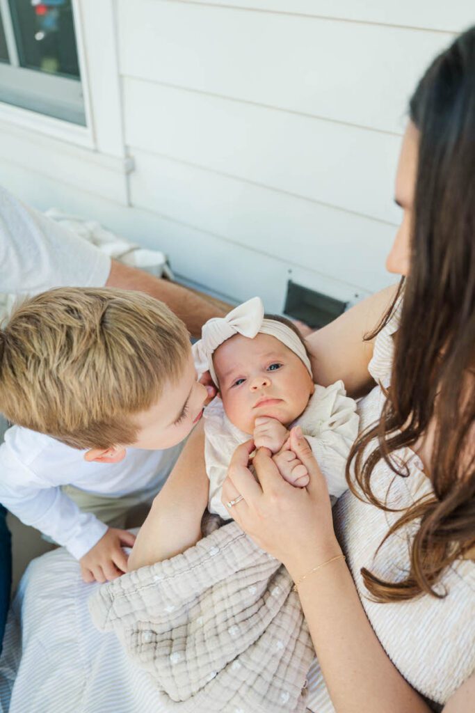 A big brother gives his new baby sister a kiss during a Louisville In-Home Family Photography Session. 

Photos by Michelle Bordenkircher Photography.